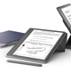 Several Kindle Scribe tablets being supported by a folding cover at different angles.
